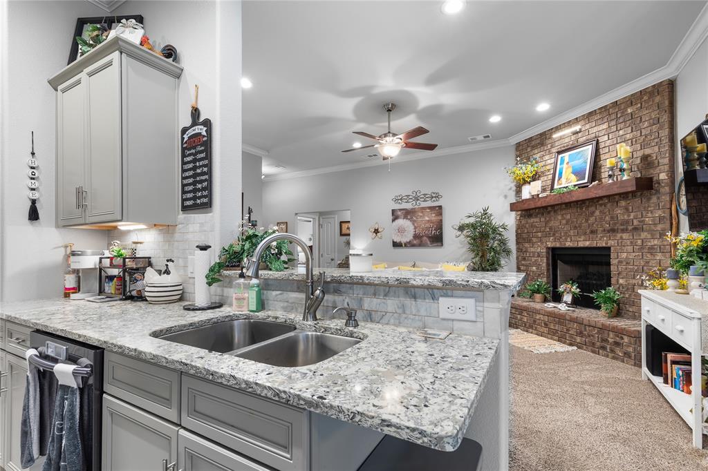 3016 Loy Lake Road Denison, TX 75020 - Photo 2 of 28 a kitchen with a sink a counter space and a fireplace