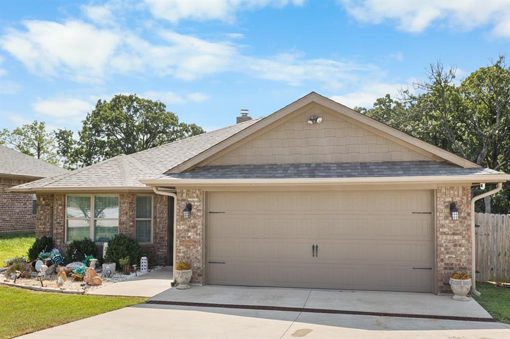 3016 Loy Lake Road Denison, TX 75020 - Photo 5 of 28 a front view of a house with garden