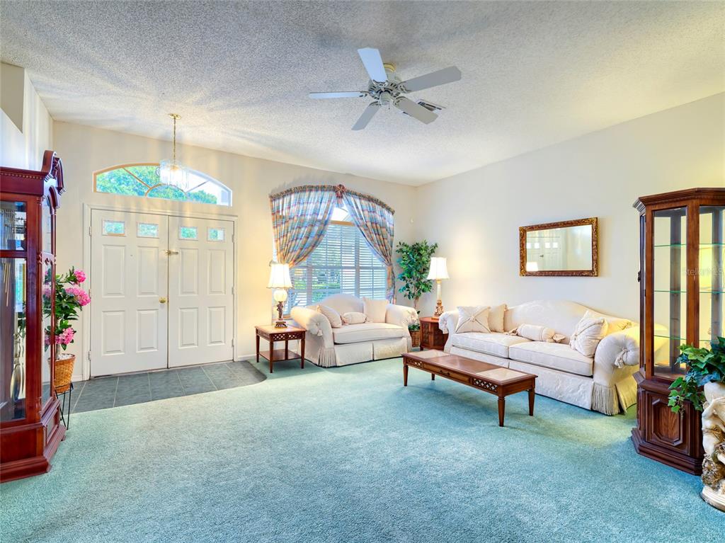 11228 Windrush Circle Hudson, FL 34667 - Photo 4 of 67 a living room with furniture and a chandelier