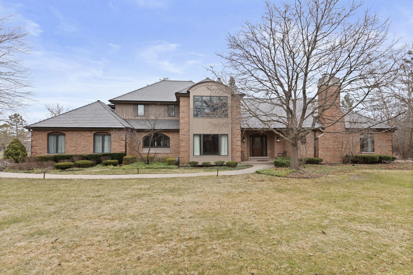 a large house with a large trees in front of it