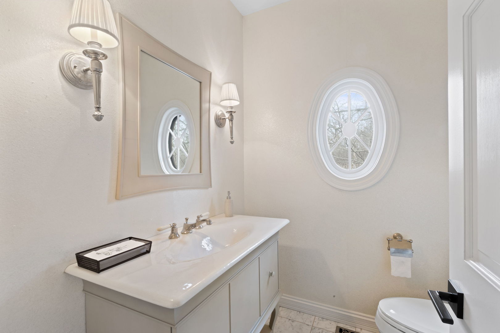 791 South Ridge Road Lake Forest, IL 60045 - Photo 16 of 40 a bathroom with a sink and a mirror