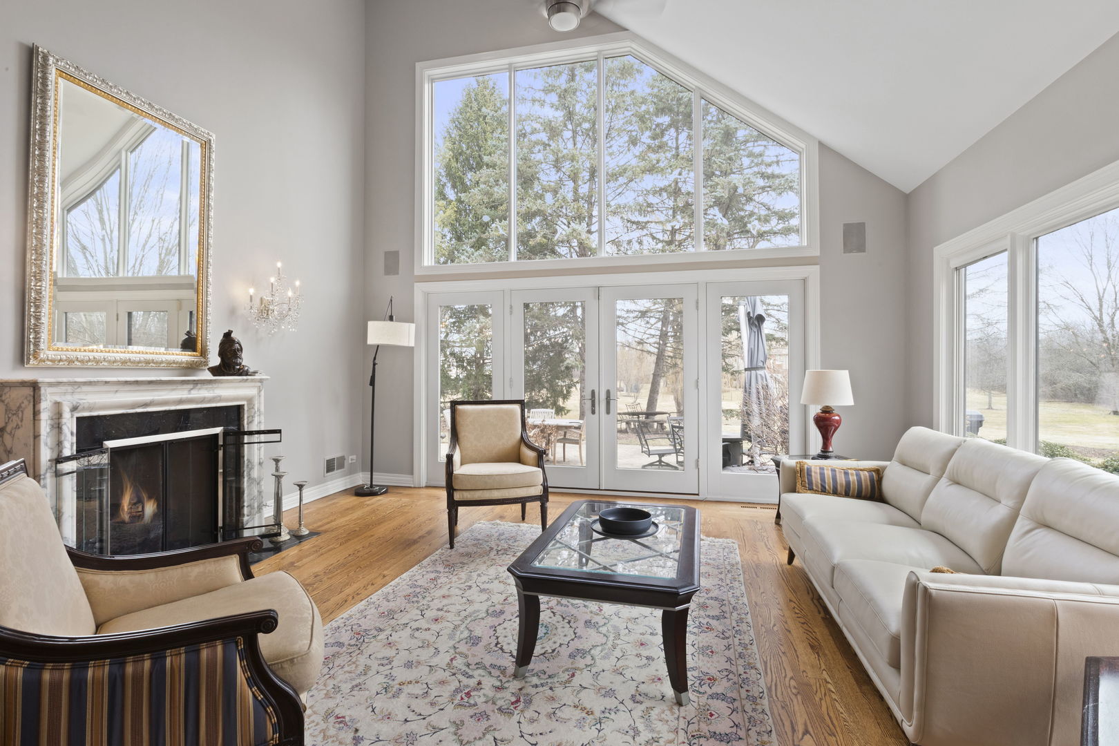 791 South Ridge Road Lake Forest, IL 60045 - Photo 6 of 40 a living room with furniture a fireplace and a large window
