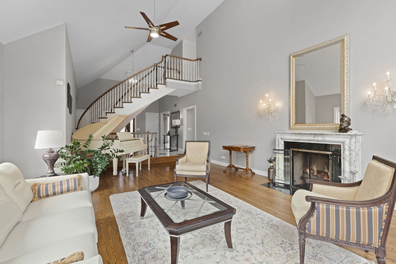 791 South Ridge Road Lake Forest, IL 60045 - Photo 7 of 40 a living room with furniture a fireplace and a chandelier