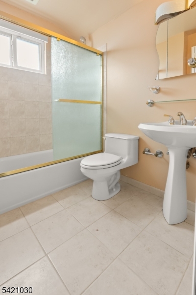 838 Florida Grove Road Perth Amboy, NJ 08861 - Photo 12 of 13 a bathroom with a sink a toilet and shower