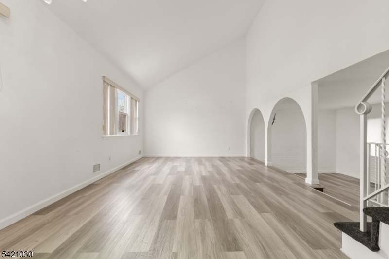 838 Florida Grove Road Perth Amboy, NJ 08861 - Photo 4 of 13 a view of empty room with window and wooden floor