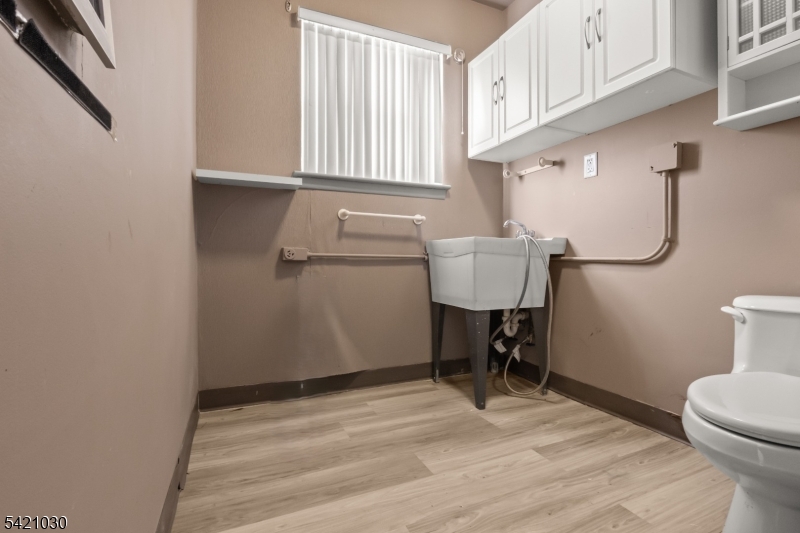 838 Florida Grove Road Perth Amboy, NJ 08861 - Photo 7 of 13 a view of a storage & utility room with a window