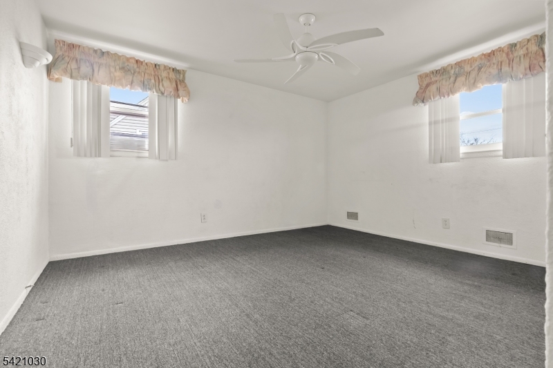 838 Florida Grove Road Perth Amboy, NJ 08861 - Photo 8 of 13 a view of an empty room with a window