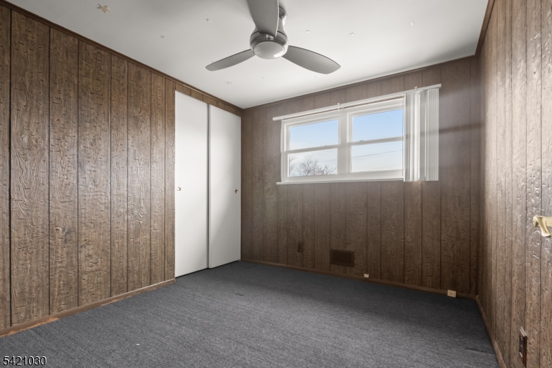 838 Florida Grove Road Perth Amboy, NJ 08861 - Photo 10 of 13 an empty room with windows and closet