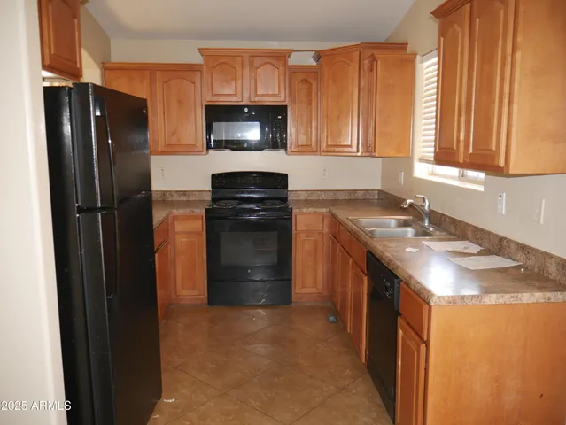 a kitchen with a sink stove and refrigerator