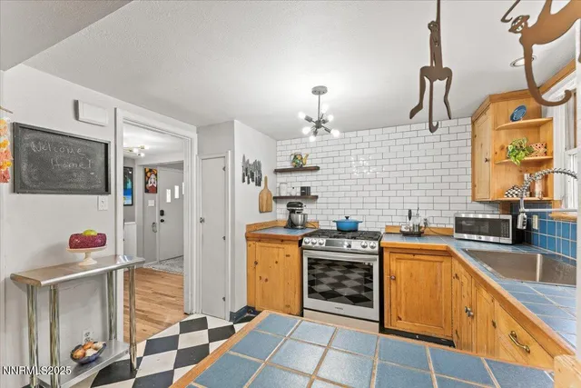 a kitchen with stainless steel appliances granite countertop a stove and a sink
