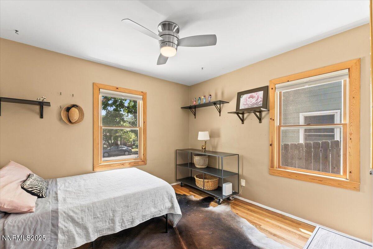 661 Thoma Street Reno, NV 89502 - Photo 15 of 33 a bedroom with a bed a table and windows