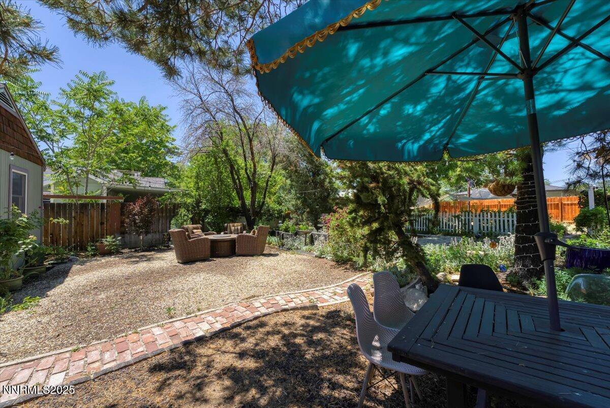 661 Thoma Street Reno, NV 89502 - Photo 25 of 33 a view of a patio with table and chairs potted plants and large tree