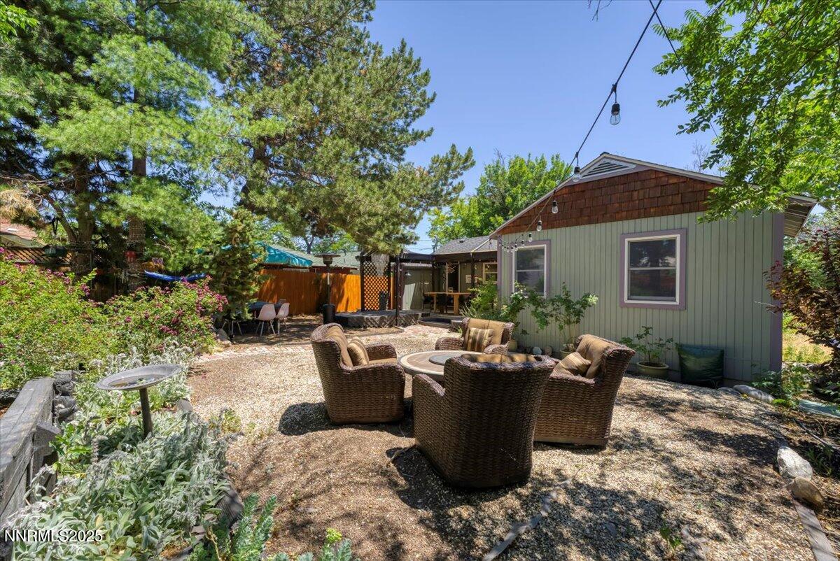 661 Thoma Street Reno, NV 89502 - Photo 27 of 33 a view of a patio with table and chairs potted plants and large tree