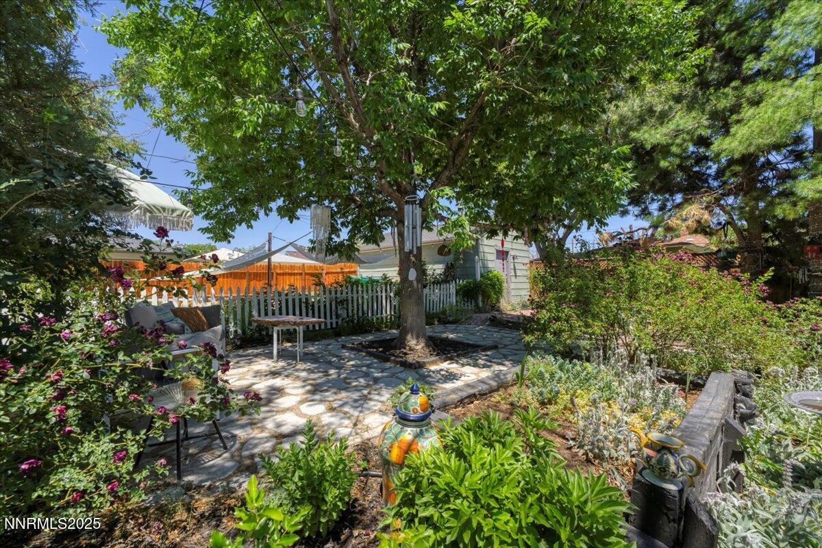 661 Thoma Street Reno, NV 89502 - Photo 28 of 33 a backyard of a house with table and chairs under an umbrella
