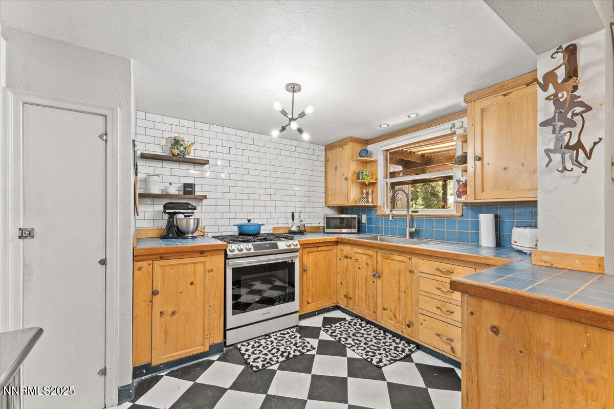 661 Thoma Street Reno, NV 89502 - Photo 10 of 33 a kitchen with stainless steel appliances granite countertop a sink and cabinets