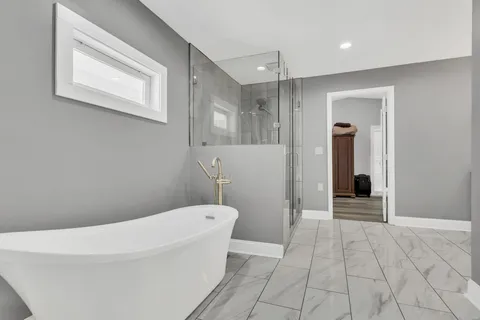 a bathroom with a bathtub and toilet