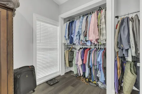 a view of walk in closet with clothes