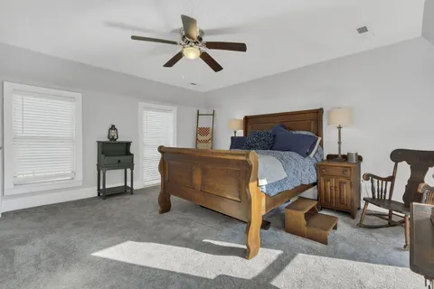 a bedroom with a bed a desk and chair