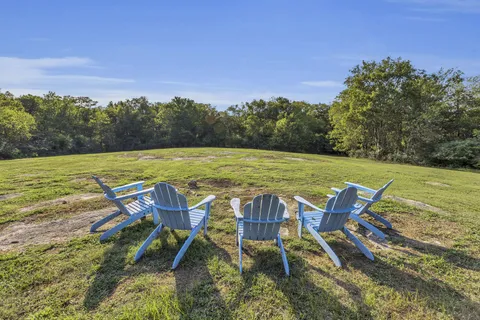 a view of a swimming pool and lounge chairs