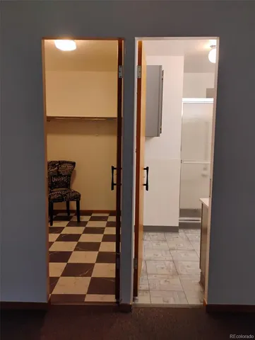 a view of closet with wooden floor
