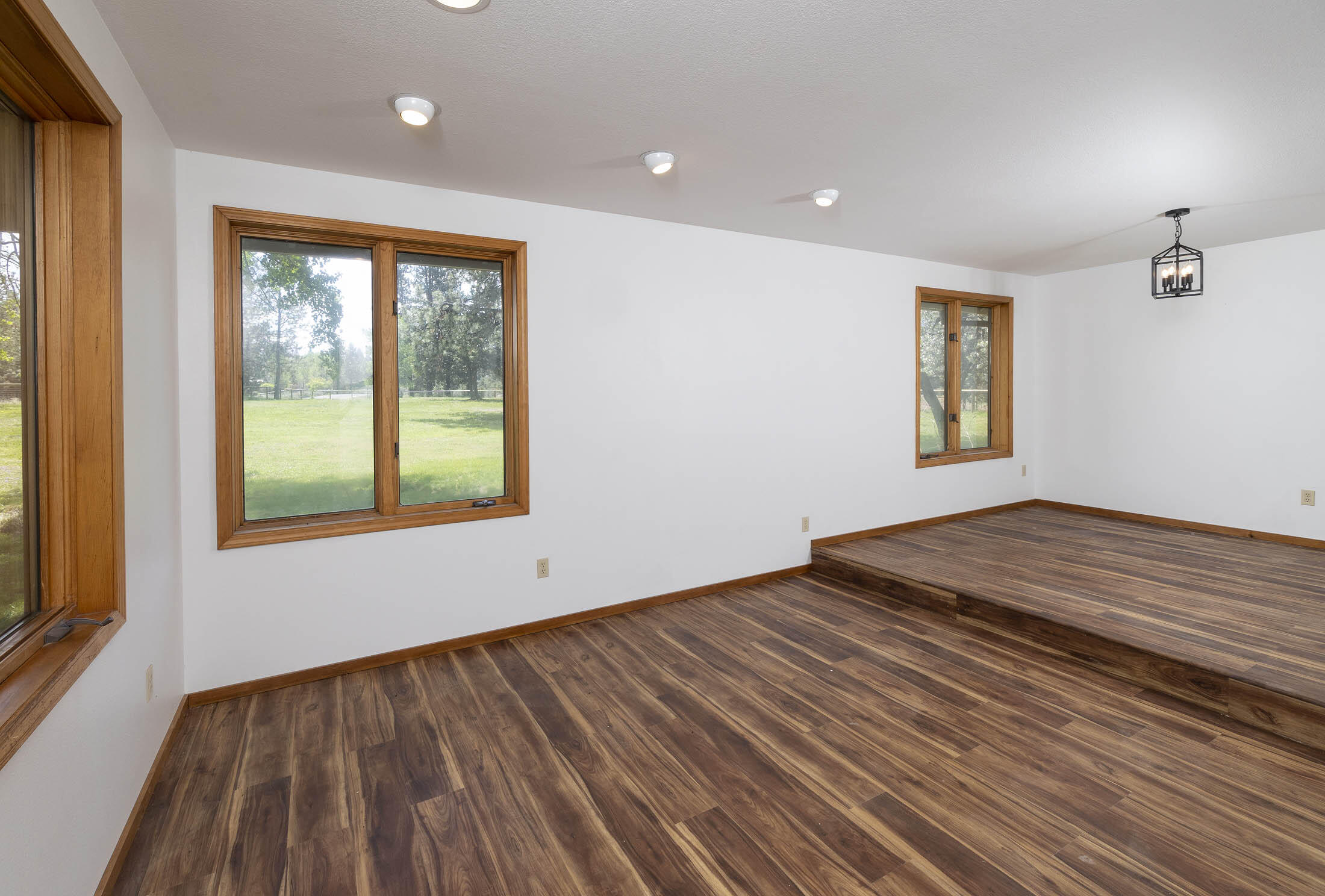 60603 Woodside Road Bend, OR 97702 - Photo 11 of 36 a view of an empty room with wooden floor and a window