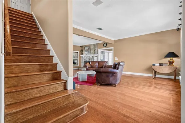 a living room with furniture and wooden floor