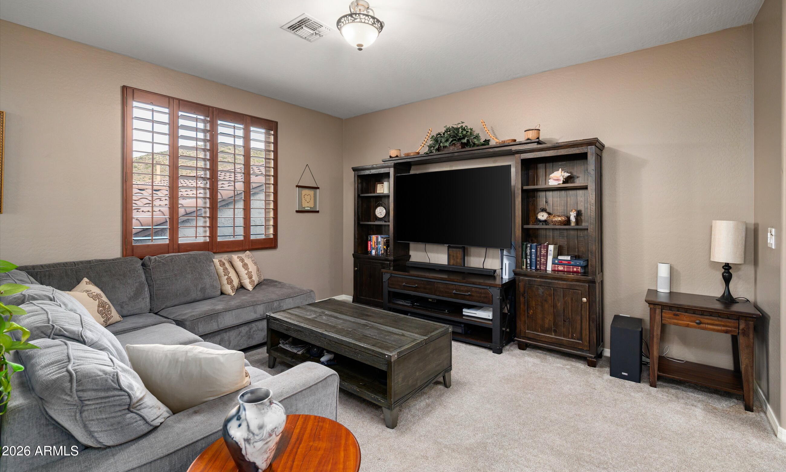 2021 West Steed Ridge Phoenix, AZ 85085 - Photo 17 of 56 a living room with furniture and a flat screen tv