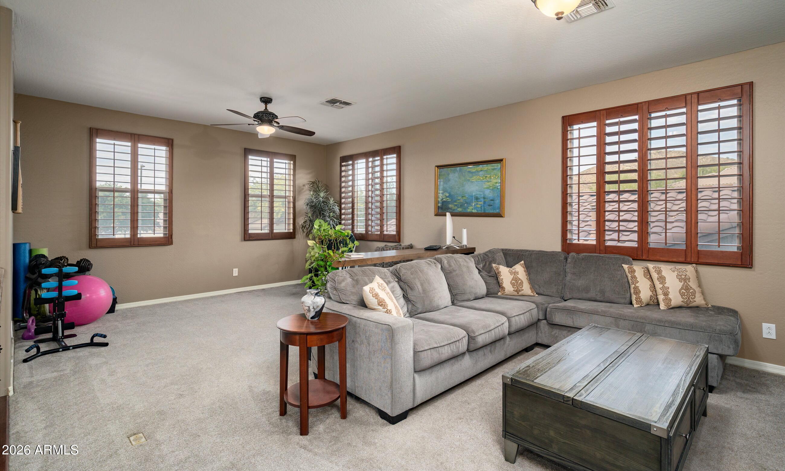 2021 West Steed Ridge Phoenix, AZ 85085 - Photo 18 of 56 a living room with furniture and a large window