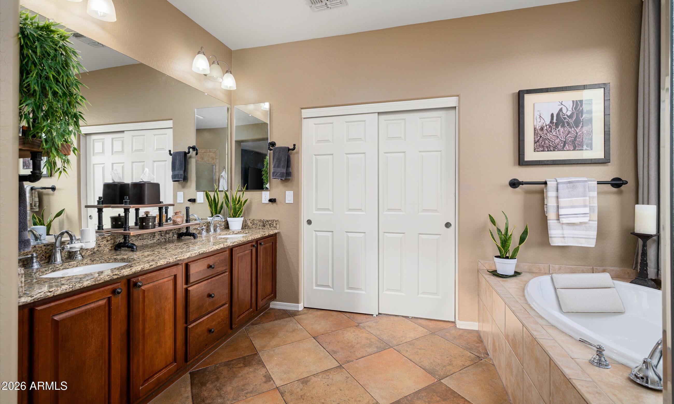 2021 West Steed Ridge Phoenix, AZ 85085 - Photo 22 of 56 a spacious bathroom with a granite countertop sink a toilet a mirror and vanity