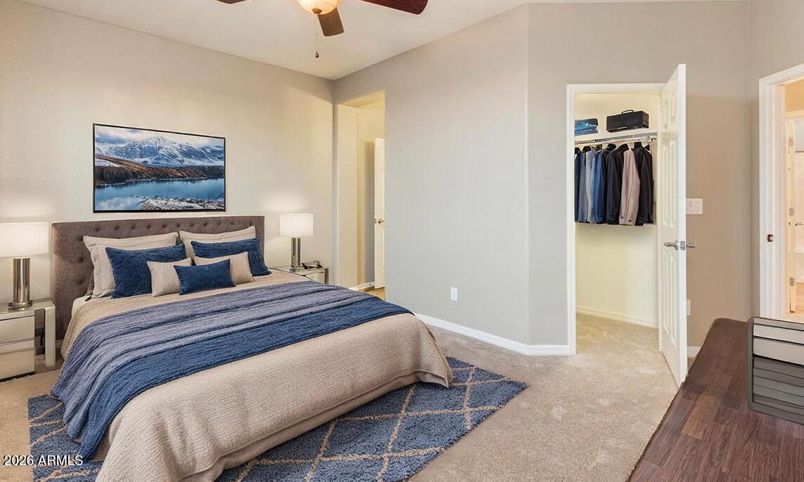 2021 West Steed Ridge Phoenix, AZ 85085 - Photo 27 of 56 a bedroom with bed and wooden floor