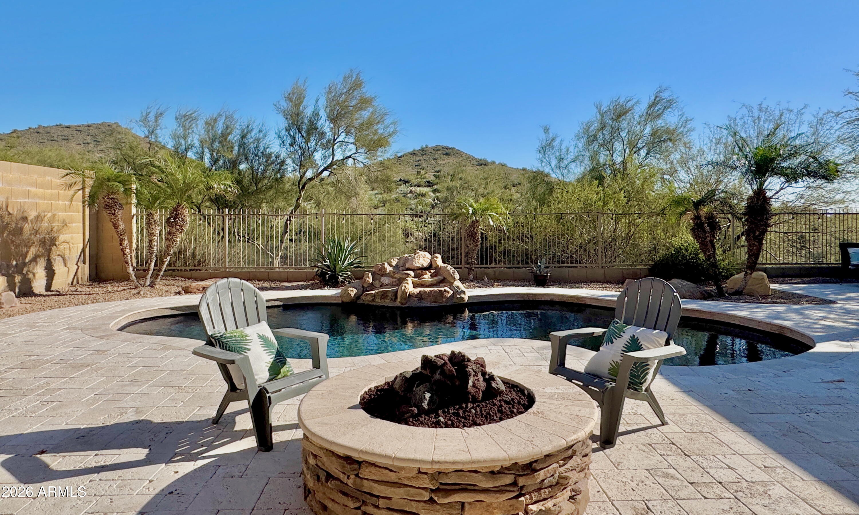 2021 West Steed Ridge Phoenix, AZ 85085 - Photo 32 of 56 a view of a swimming pool with a patio and a fire pit