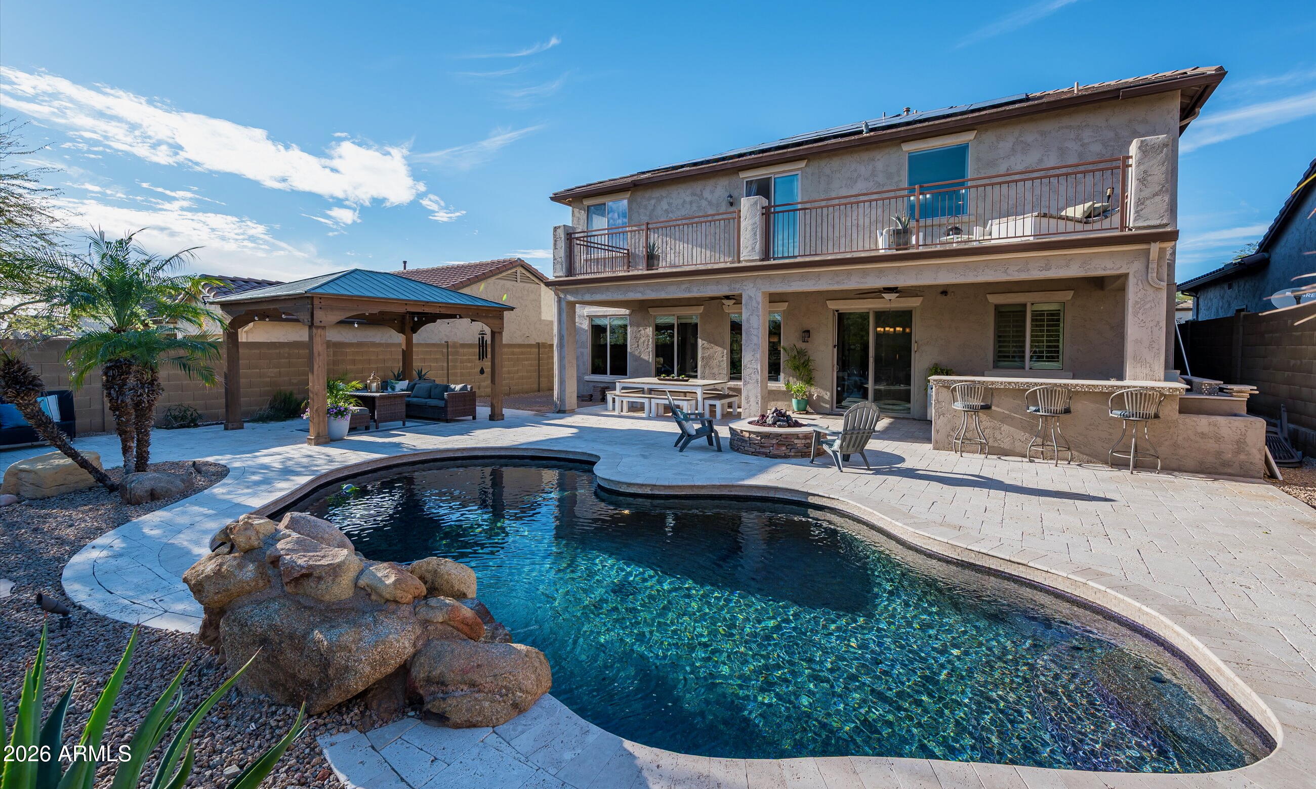2021 West Steed Ridge Phoenix, AZ 85085 - Photo 35 of 56 a view of a house with swimming pool and sitting area
