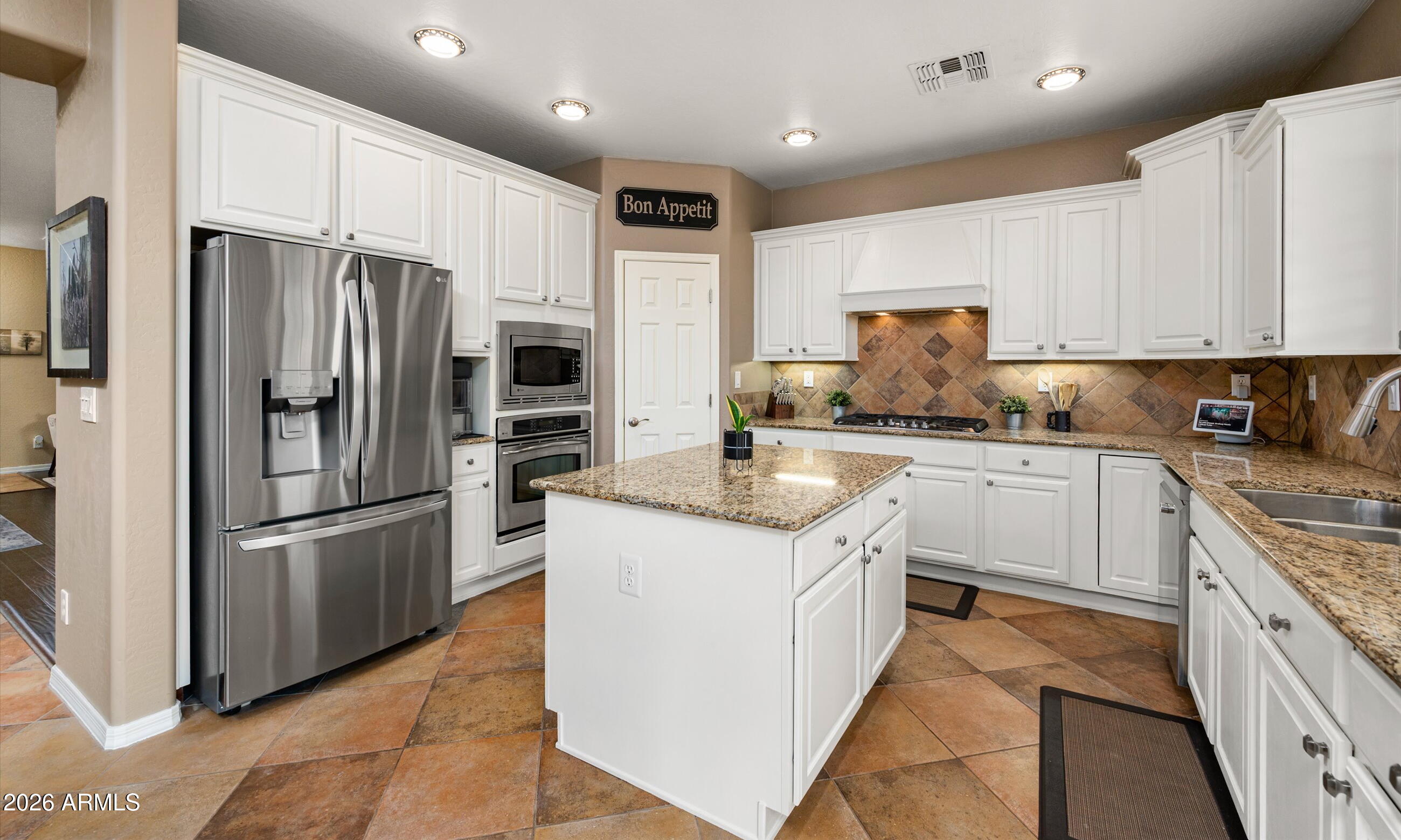 2021 West Steed Ridge Phoenix, AZ 85085 - Photo 6 of 56 a kitchen with stainless steel appliances granite countertop a refrigerator sink and cabinets