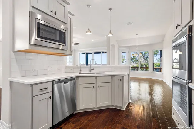 a kitchen with a sink microwave and stove