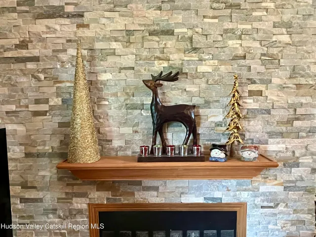 an aerial view of a residential houses with outdoor space and trees all around