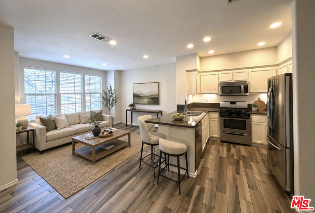 27030 Victoria Lane, Unit 76 Valencia, CA 91355 - Photo 1 of 19 a living room with furniture and a flat screen tv
