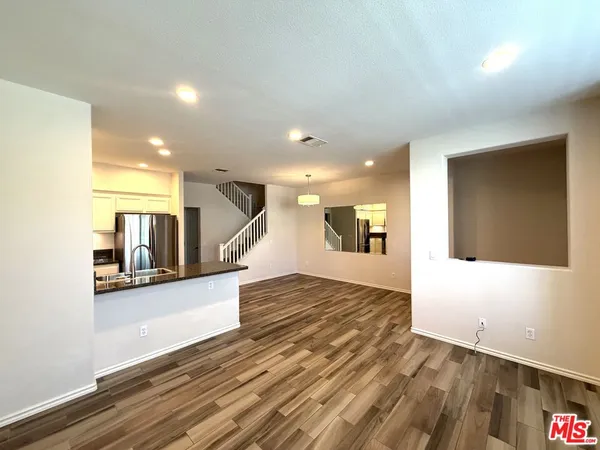 a view of hallway with wooden floor