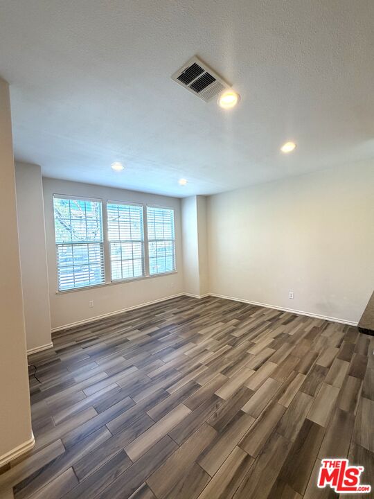 27030 Victoria Lane, Unit 76 Valencia, CA 91355 - Photo 6 of 19 a view of empty room with wooden floor and fan