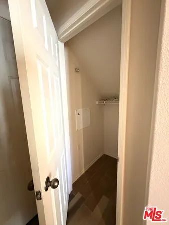 an empty room with windows and chandelier fan
