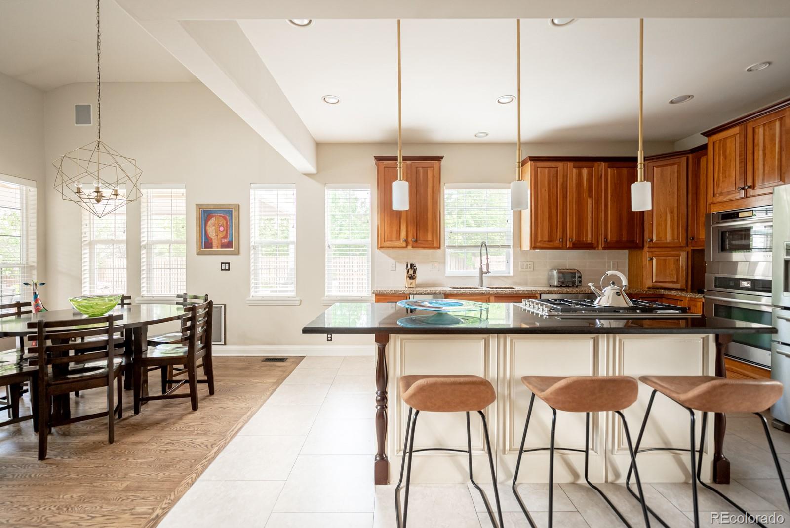 3350 Oak Street Wheat Ridge, CO 80033 - Photo 11 of 40 a large kitchen with lots of counter space and dining table