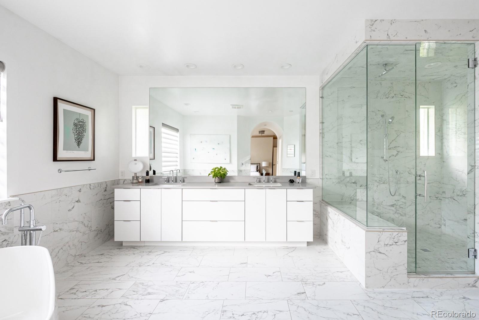 3350 Oak Street Wheat Ridge, CO 80033 - Photo 20 of 40 a bathroom with a bathtub sink mirror and vanity