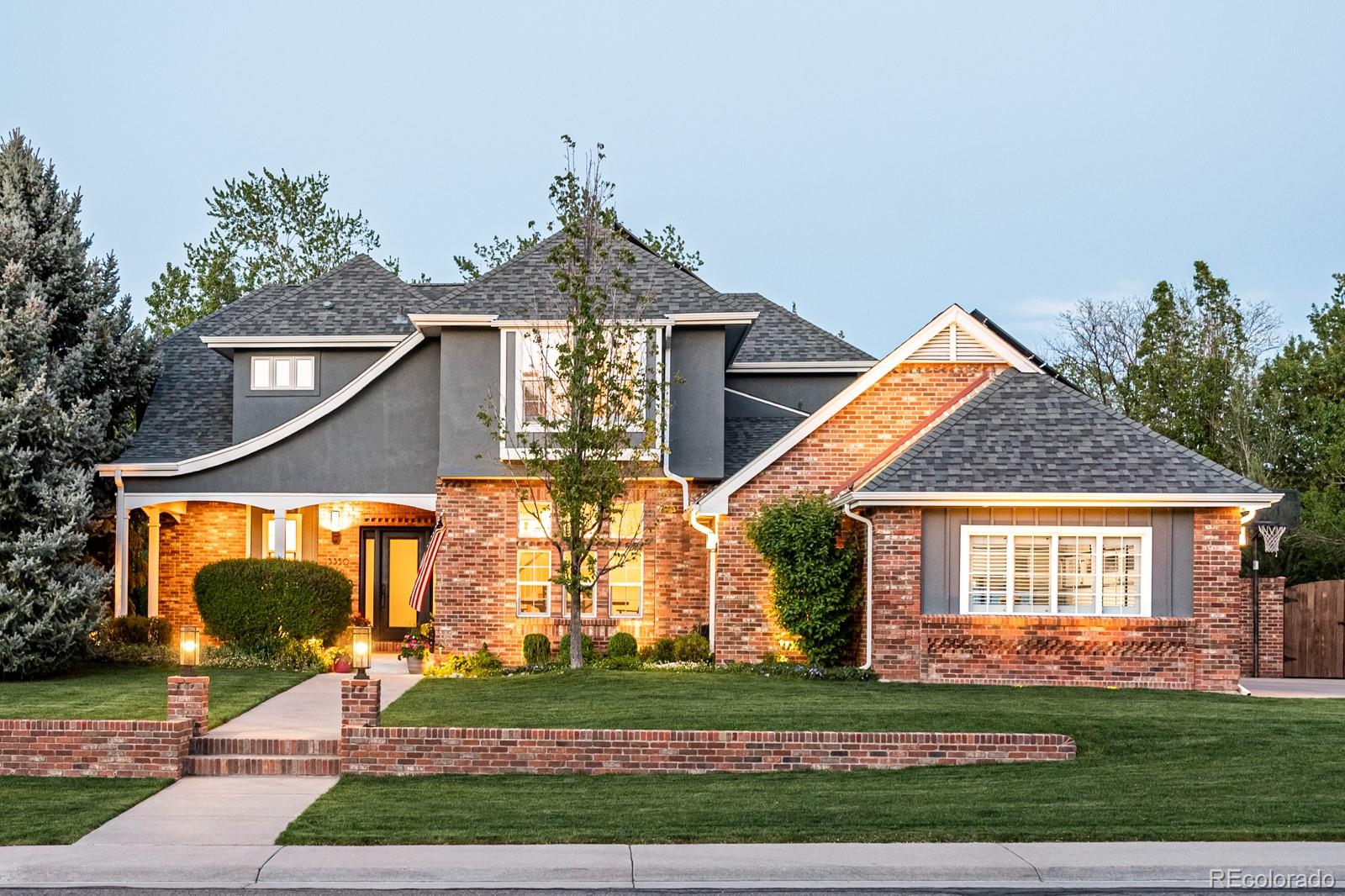 3350 Oak Street Wheat Ridge, CO 80033 - Photo 2 of 40 a front view of a house with a yard