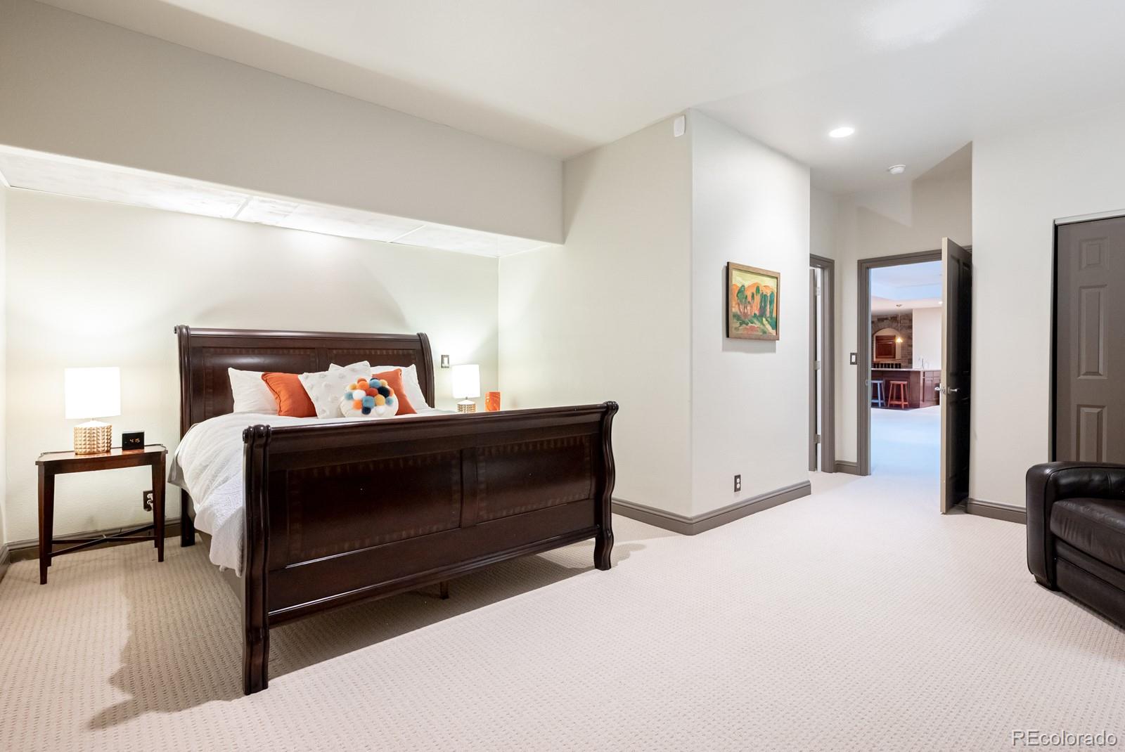 3350 Oak Street Wheat Ridge, CO 80033 - Photo 28 of 40 a bedroom with a bed and a tv on table