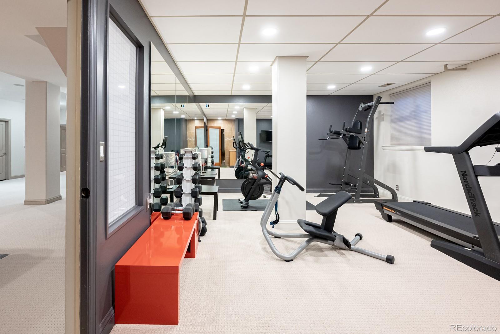 3350 Oak Street Wheat Ridge, CO 80033 - Photo 29 of 40 a room with gym equipment and view of living room