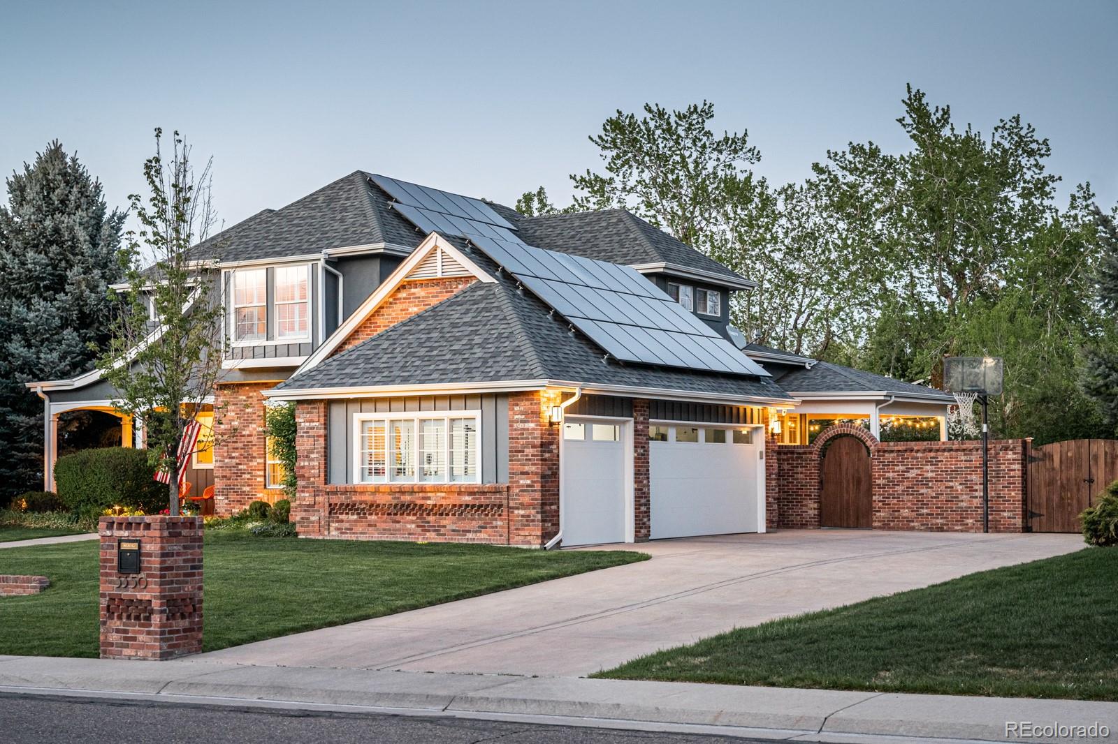 3350 Oak Street Wheat Ridge, CO 80033 - Photo 3 of 40 a front view of a house with a garden and trees