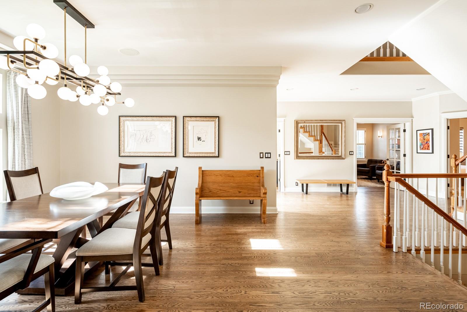 3350 Oak Street Wheat Ridge, CO 80033 - Photo 8 of 40 a dining room with wooden floor a chandelier a wooden table and chairs