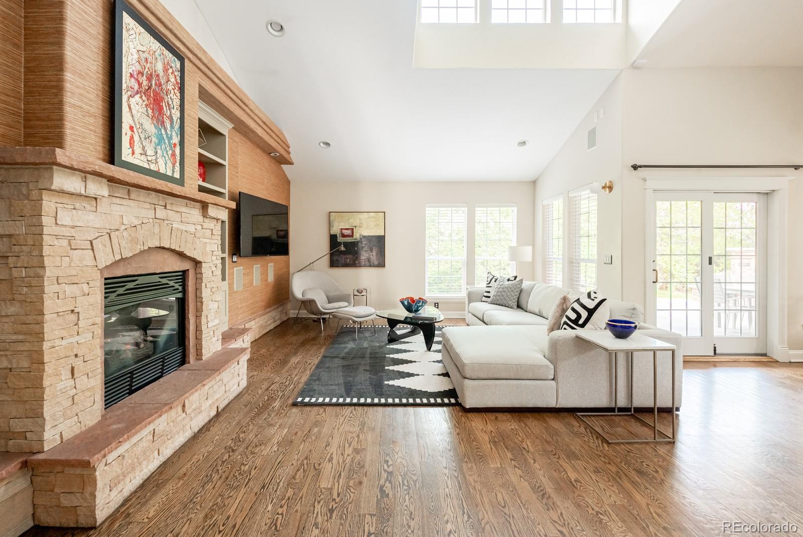 3350 Oak Street Wheat Ridge, CO 80033 - Photo 9 of 40 a living room with furniture large window and a fireplace