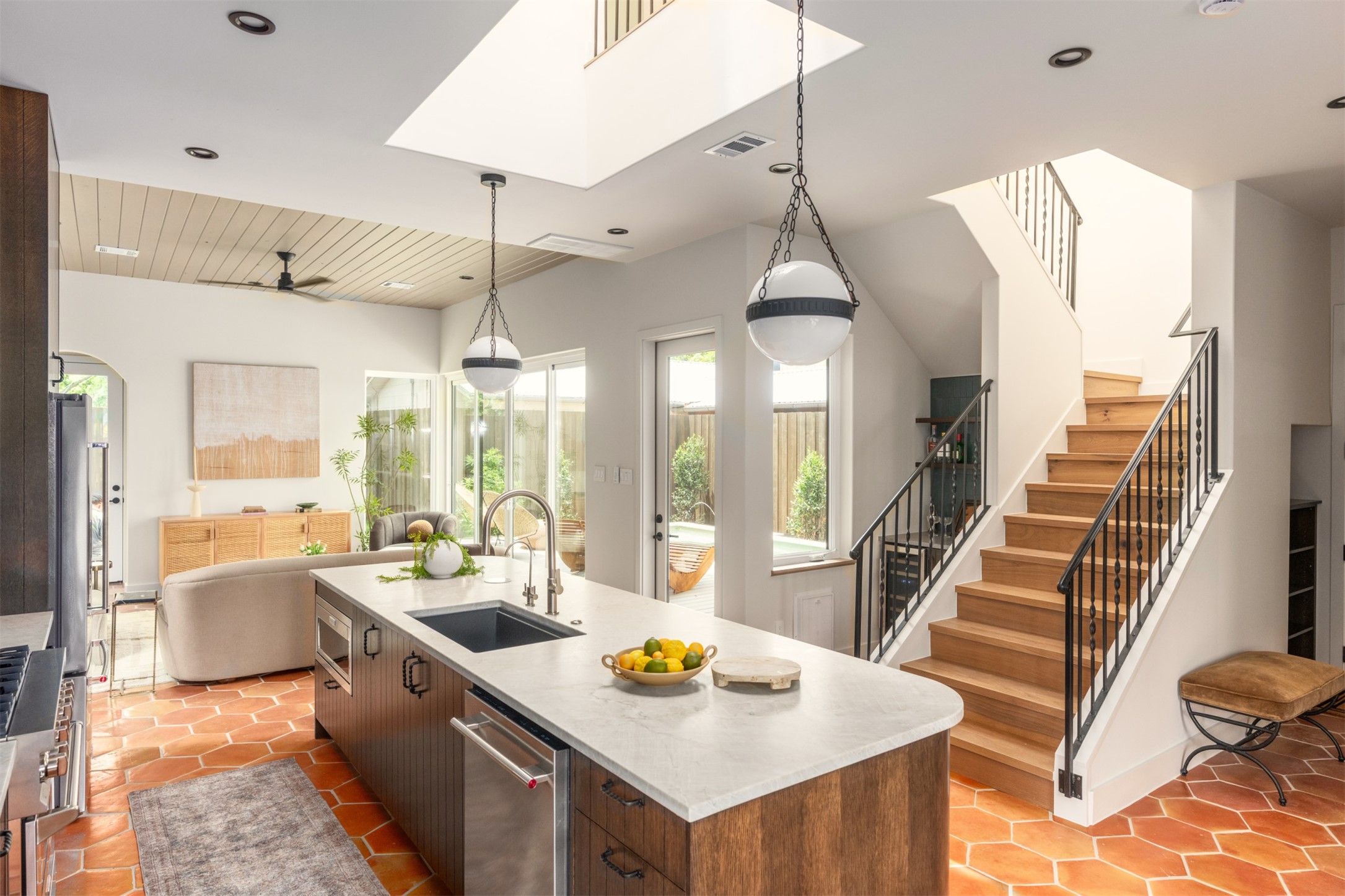 4713 Bolm Road Austin, TX 78702 - Photo 12 of 40 Bright kitchen island with integrated sink and dishwasher, complemented by terracotta hex tile flooring