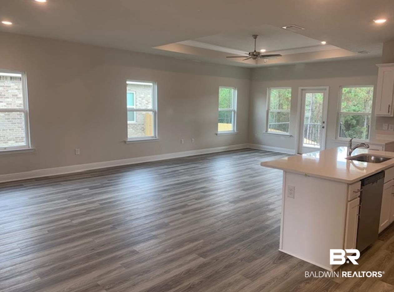 12904 Grand Rpds Road Fairhope, AL 36532 - Photo 28 of 34 Kitchen featuring white cabinets, dark hardwood / wood-style floors, sink, and dishwasher