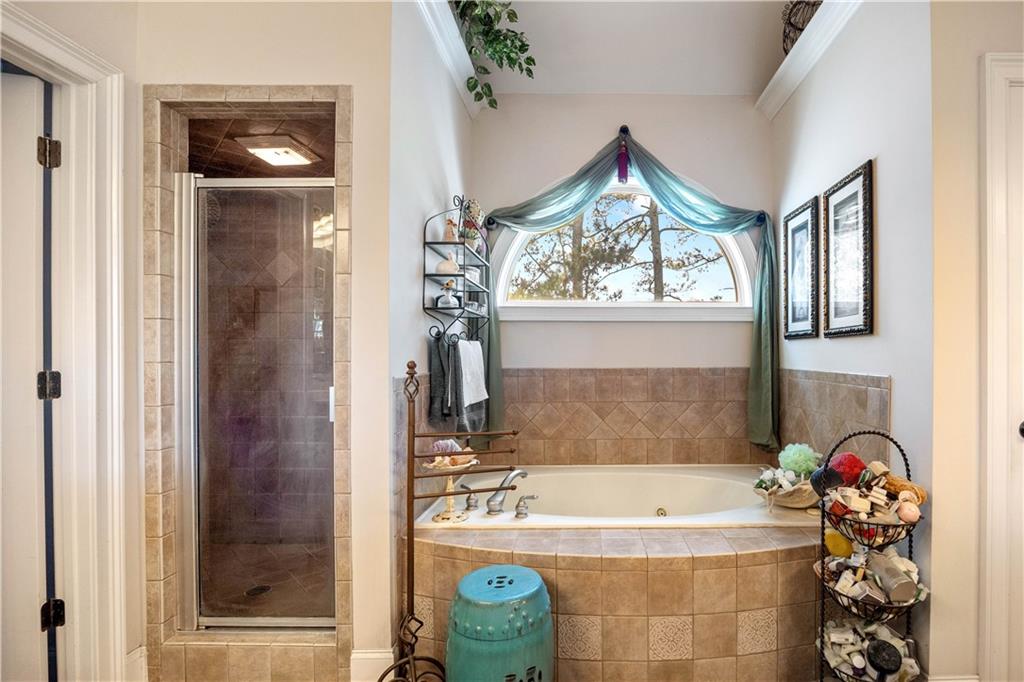 802 Pathview Court Dacula, GA 30019 - Photo 16 of 50 a bathroom with a bathtub and a shower
